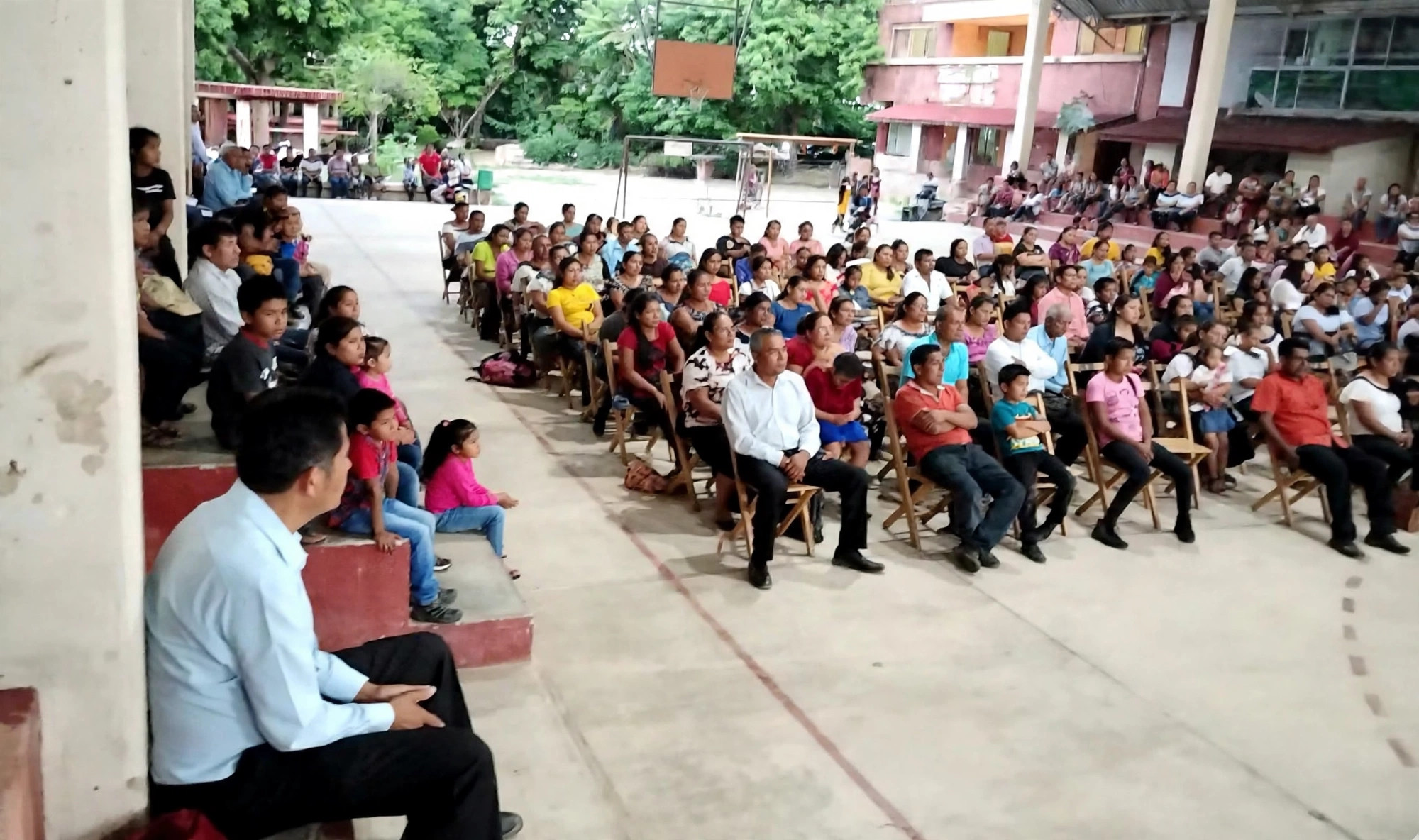 Seated crowd listening to the gospel at night in Chiapas
